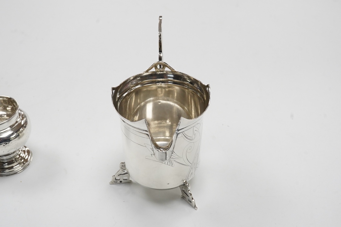 A late 19th/early 20th century Russian 84 zolotnik cream jug, with engraved decoration and angular feet and handle, master Andrei Ivanov, 1908-1917 kokoshnik mark, height 11.6cm, together with a similar single handled sm